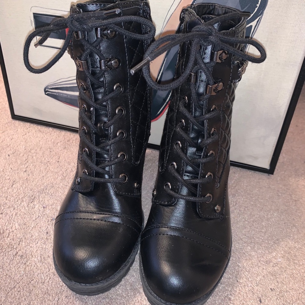 Black heeled combat boots with a chain
